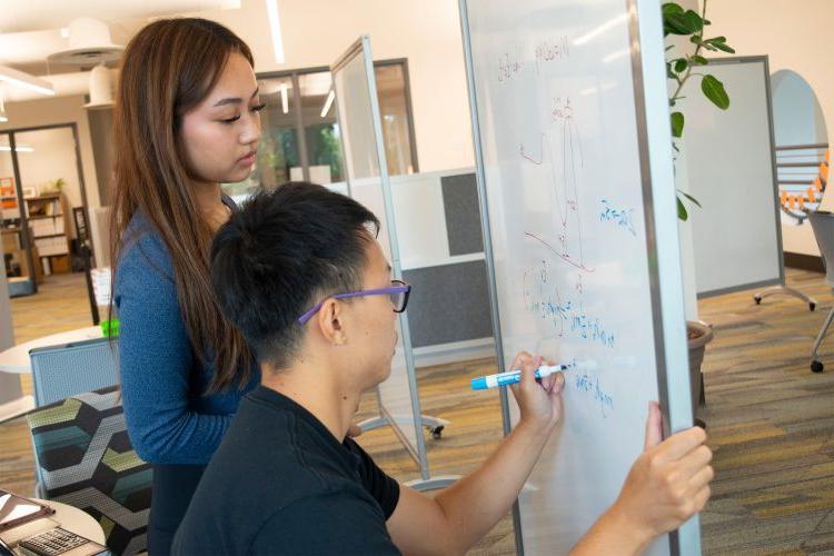 a student works with a peer tutor in the tutoring center